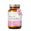 Udo's Choice Babies & Toddler's Blend Microbiotics Powder in an amber glass bottle with a silver metal cap and a pink hanging tag labeled Infant Probiotic, on a white background.