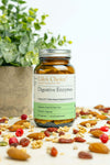 Bottle of Udo's Choice Digestive Enzymes with a background of nuts and berries
